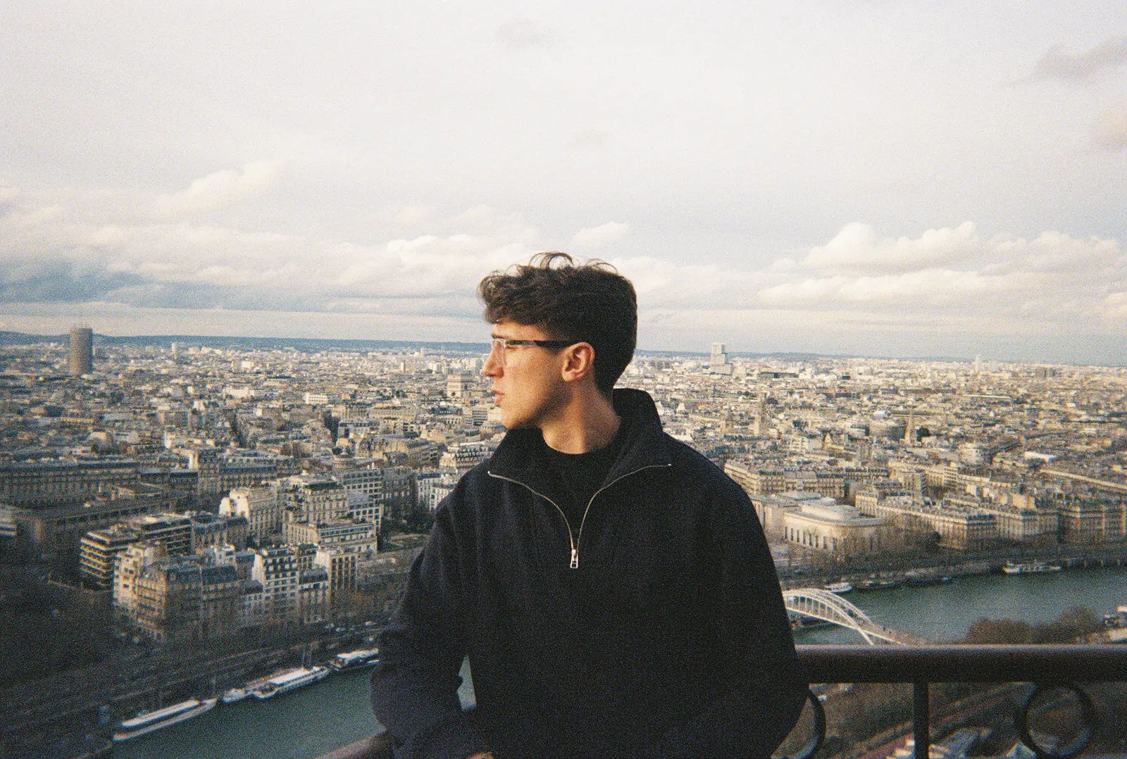 Aidan on the Eiffel Tower, looking out over Paris. Film photo.